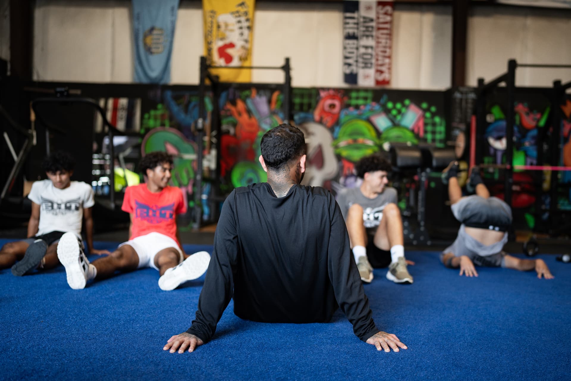 Athletes stretching together during a group session at The Pack
