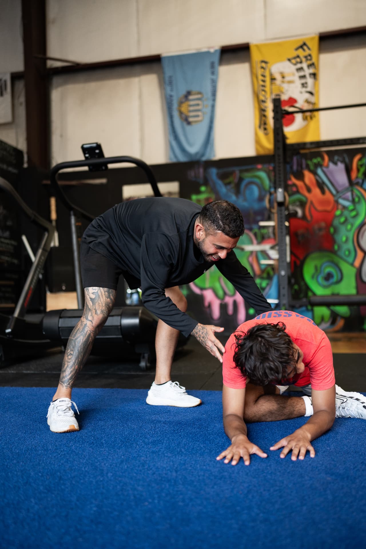 Coach guiding an athlete through a mobility drill at The Pack
